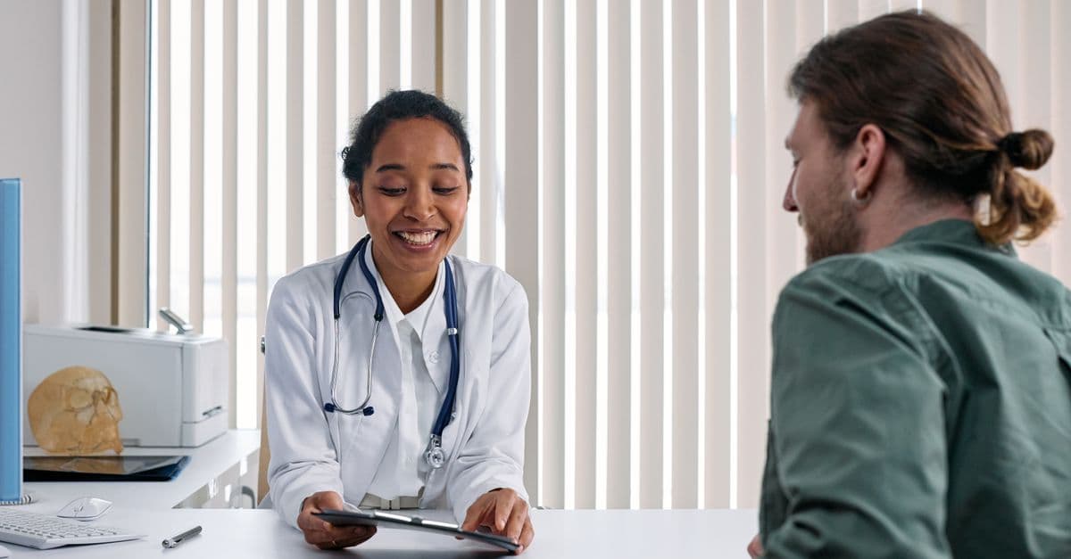 A doctor and patient engaging in a positive consultation in a clinic