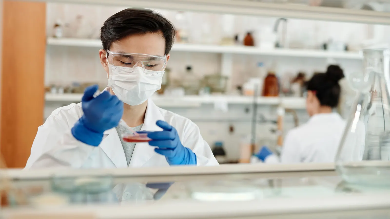 A laboratory technician handling blood sample tubes