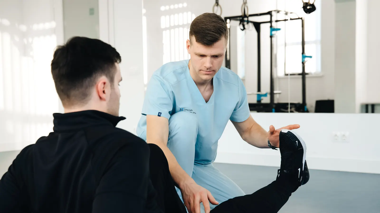 A clinician treating a patient's leg during a therapy session