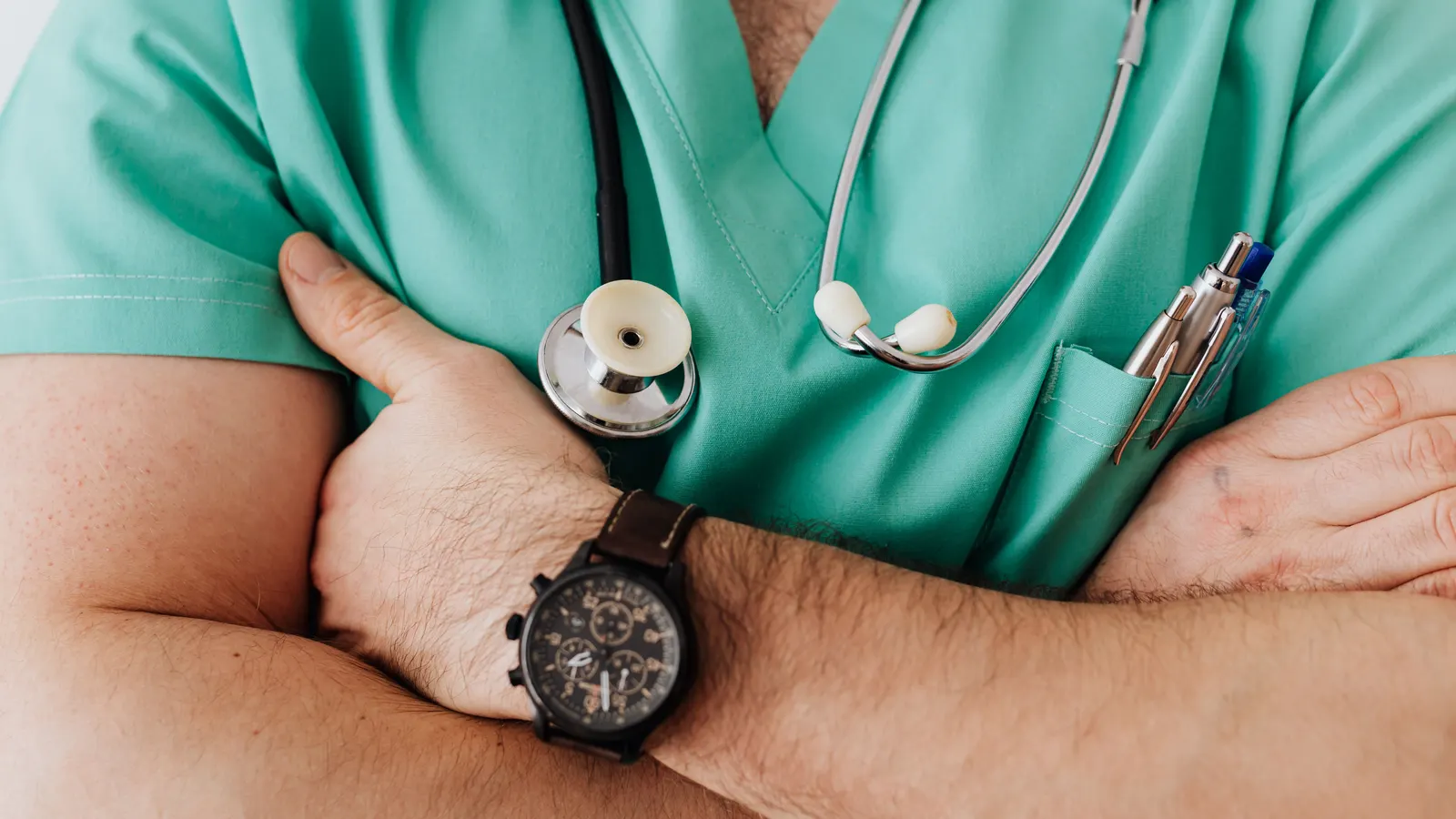 A clinician's hands preparing to examine a patient